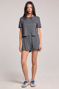 A full body front view of a woman wearing the Chaser Future Grey Harper Shorts on a neutral background