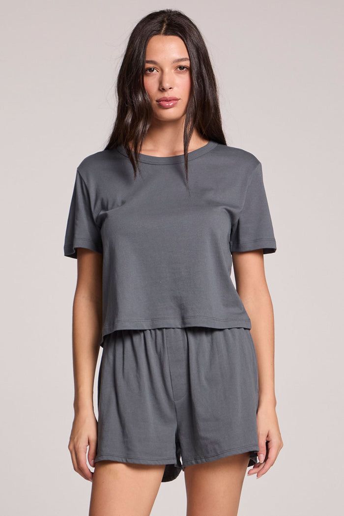 Front view of a woman wearing the Chaser Future Grey Jameson Tee and coordinated Harper shorts on a neutral background