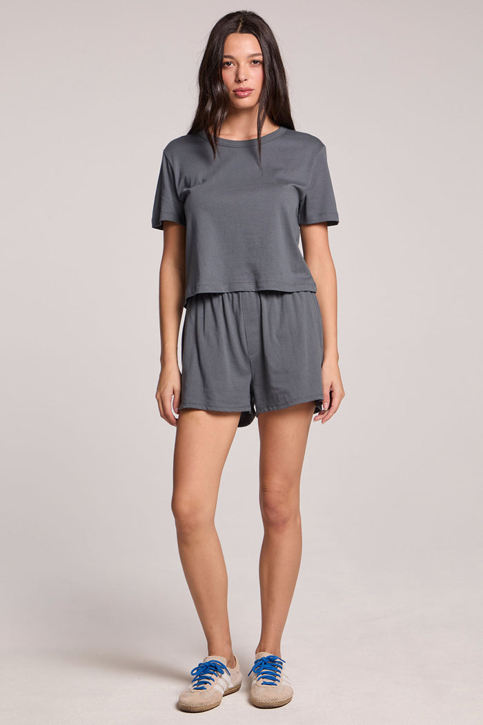 Front full body view of a woman wearing the Chaser Future Grey Jameson Tee and Harper shorts on a neutral background