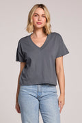 Front view of a woman wearing the Chaser Future Grey Mazzy Tee and jeans on a neutral background