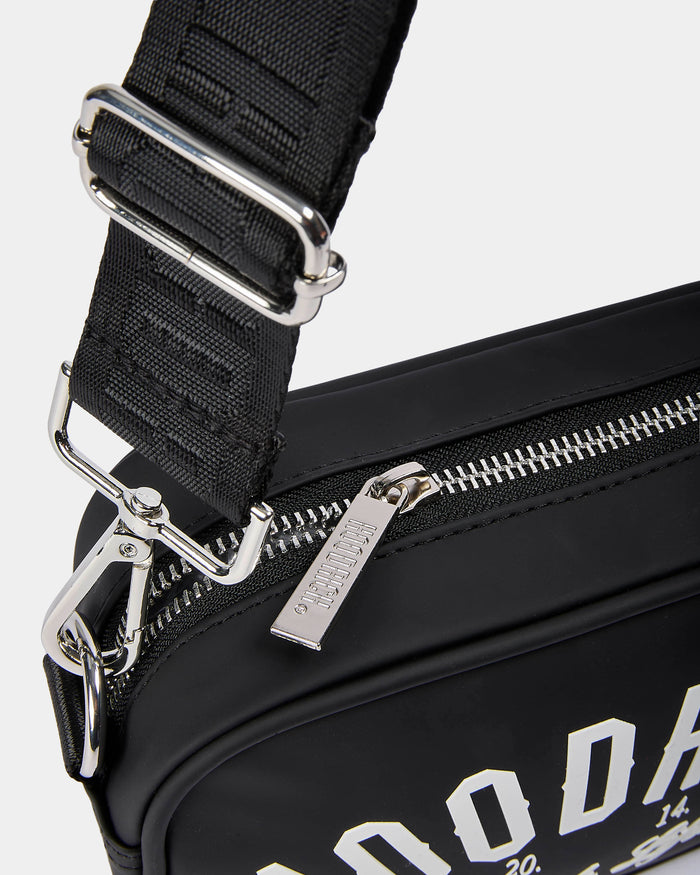 Black bag with silver zippers and hardware on a white background