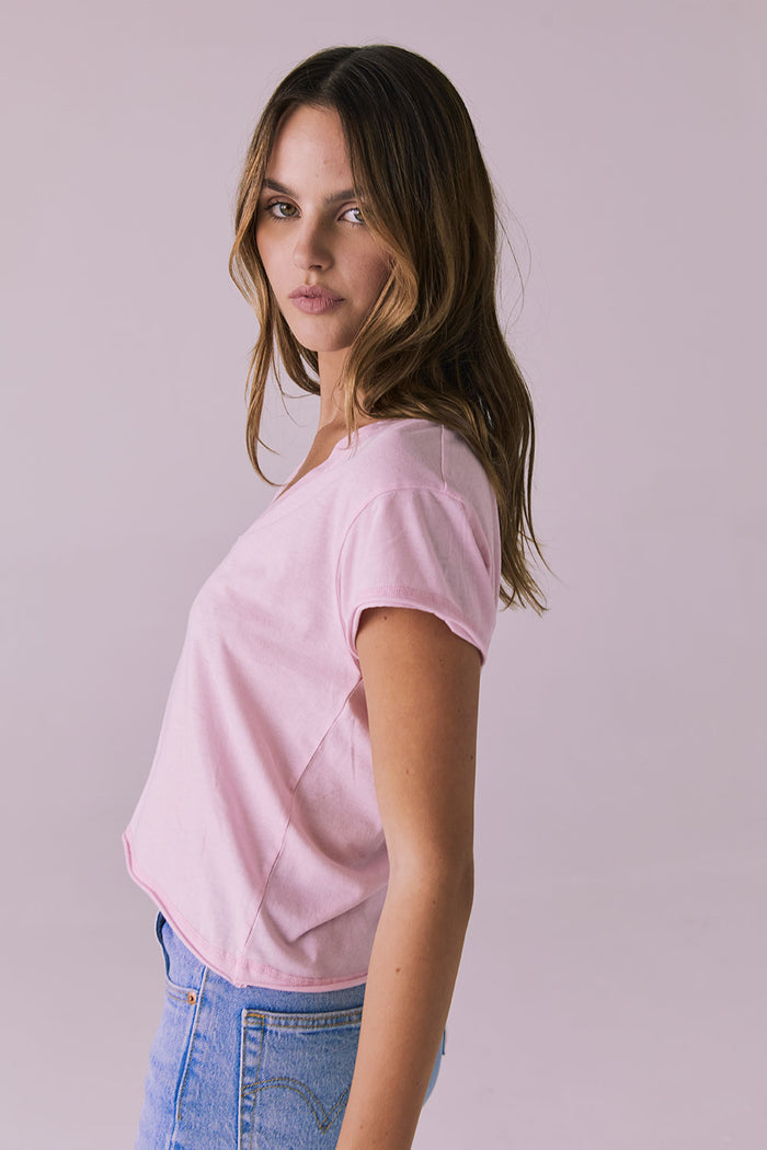 Side studio image of the Chaser Gator V Neck Nose Pink Tee highlighting the easy drape and rolled sleeve detail
