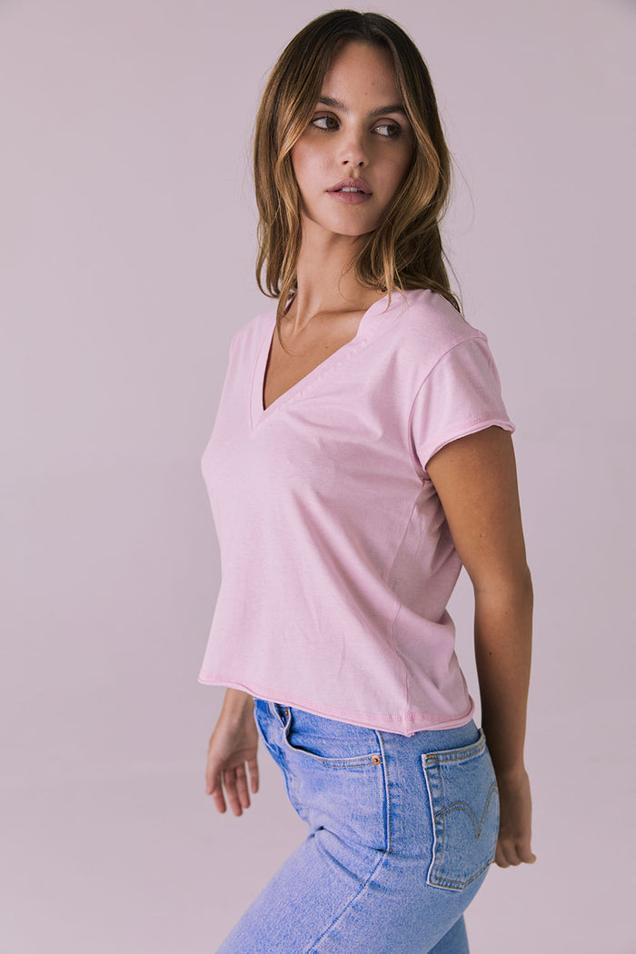 Studio image of the Chaser Gator V Neck Nose Pink Tee turning slightly to the side showing flattering V neckline and natural flow