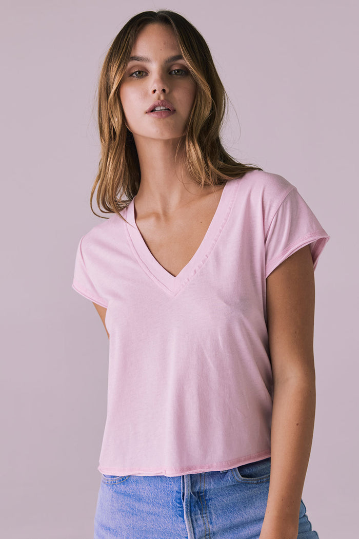 Front-facing studio image of the Chaser Gator V Neck Nose Pink Tee styled with light denim highlighting neckline seam and feminine cut