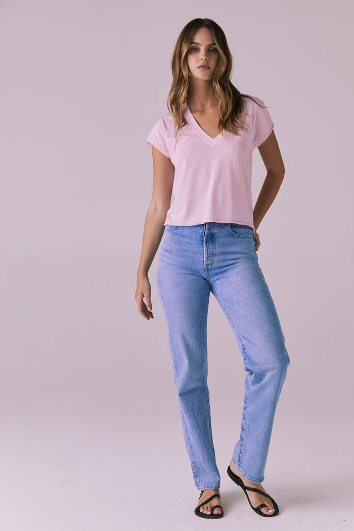 Full-length studio image of the Chaser Gator V Neck Nose Pink Tee styled with straight-leg jeans and black sandals showing easy everyday wear