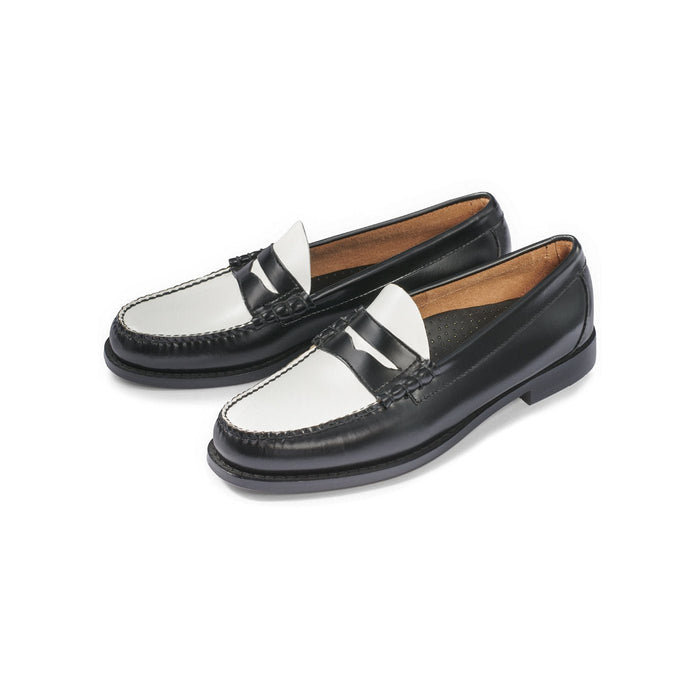 Black and white leather penny loafers, angled pair view.