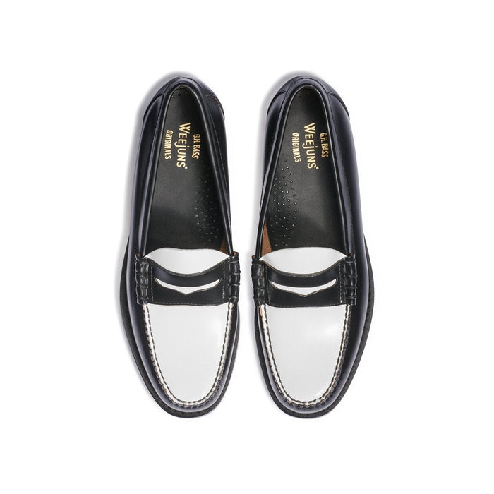 Black and white leather penny loafers, top-down view.