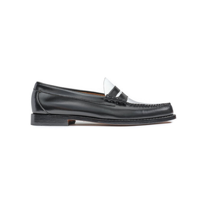 Black and white leather penny loafer, side profile view.