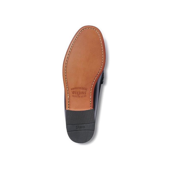 Sole of a black and white leather loafer, tan leather sole with Weejuns branding.