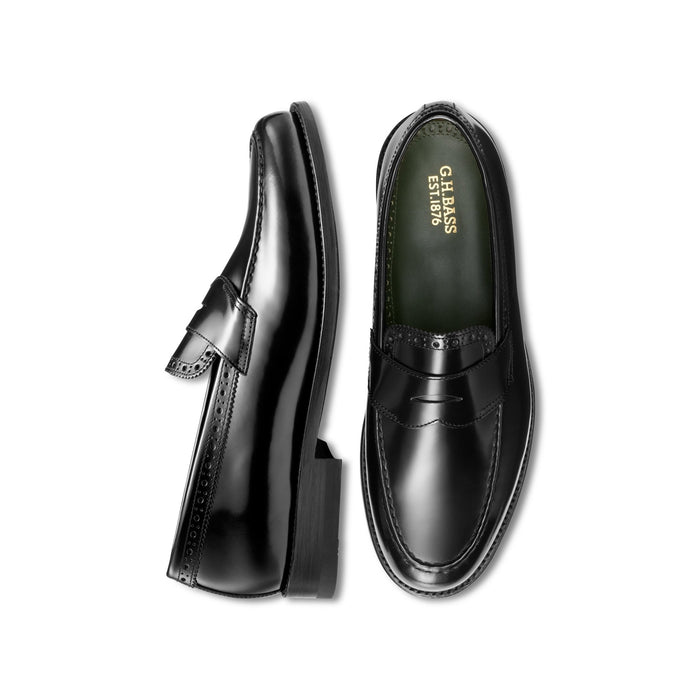 Black leather loafer with perforated brogue trim, top-down and side profile view.