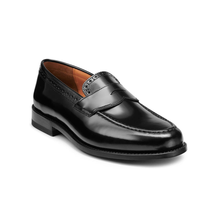 Black leather loafer with perforated brogue trim, three-quarter angle view.