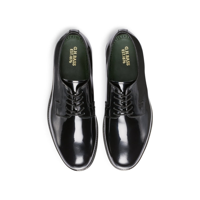 Black patent leather lace-up derby shoes, top-down view showing green insoles.