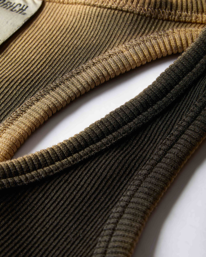 Close-up of ribbed knit fabric in brown and black on a white background