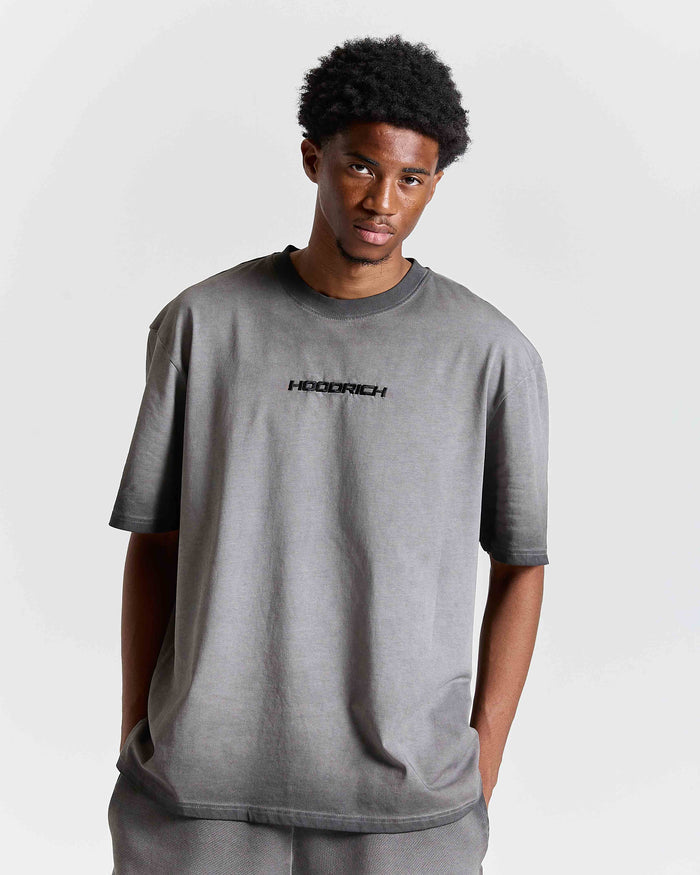 Person wearing a gray t-shirt with 'HOODRICH' logo on a plain background