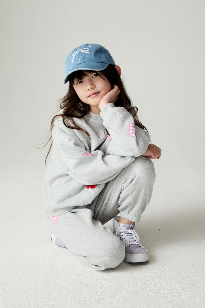 Girl crouching down wearing the Chaser irl Power Medley Girls Long Sleeve on a neutral background and matching pants