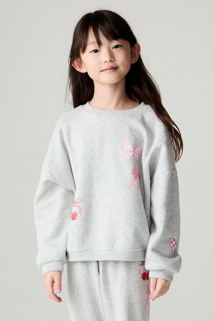 Front view of a girl wearing the Chaser irl Power Medley Girls Long Sleeve on a neutral background and matching grey pants