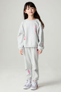 Full body front view of a girl wearing the Chaser Girl Power Medley Pants Girls Jogger set on a neutral background