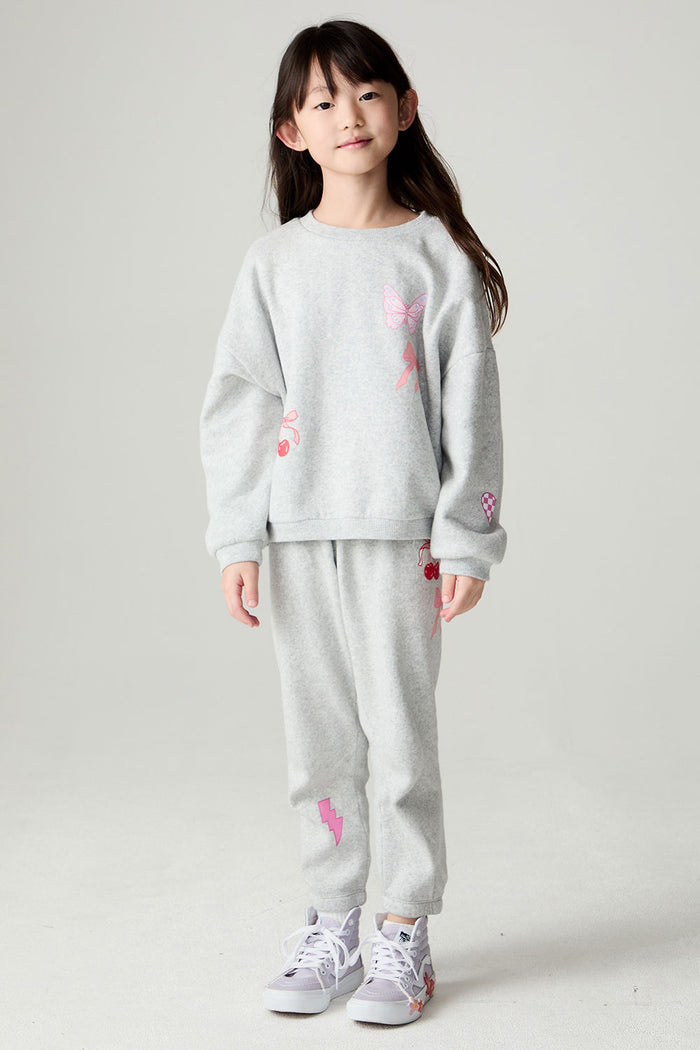 Full body front view of a girl wearing the Chaser Girl Power Medley Pants Girls Jogger set on a neutral background