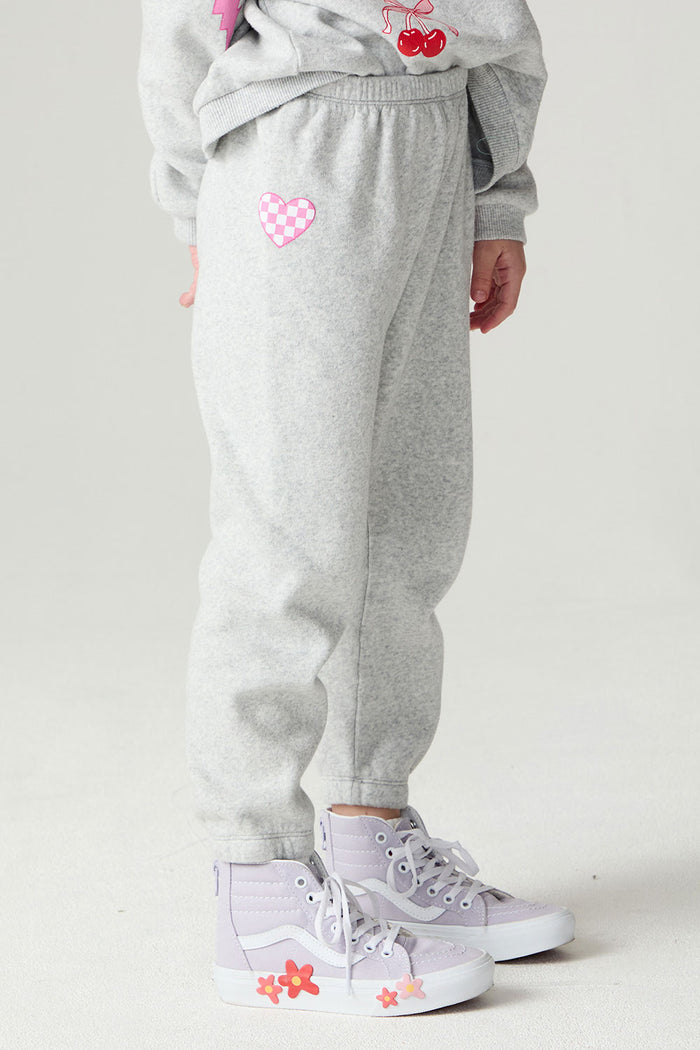 Front angle view of a girl wearing the Chaser Girl Power Medley Pants Girls Jogger on a neutral background with hands at sides