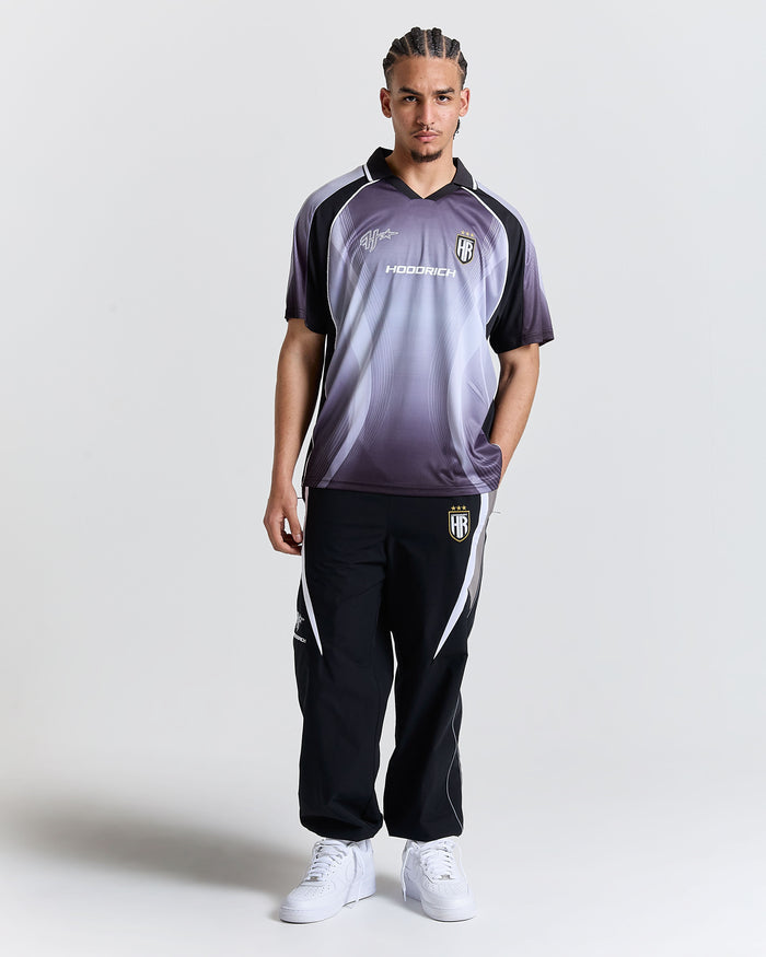 Person wearing a sports outfit with a logo on a white background