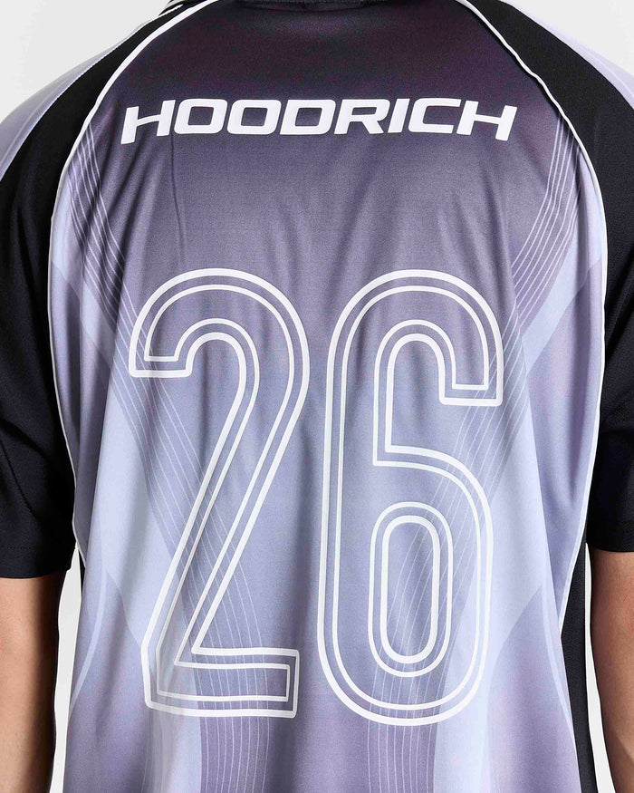 Close-up of the back of a short-sleeve athletic jersey with the brand name HOOORICH across the upper back and the number 26 outlined in white. The jersey has a gray-to-white gradient body with black sleeves and shoulder panels.