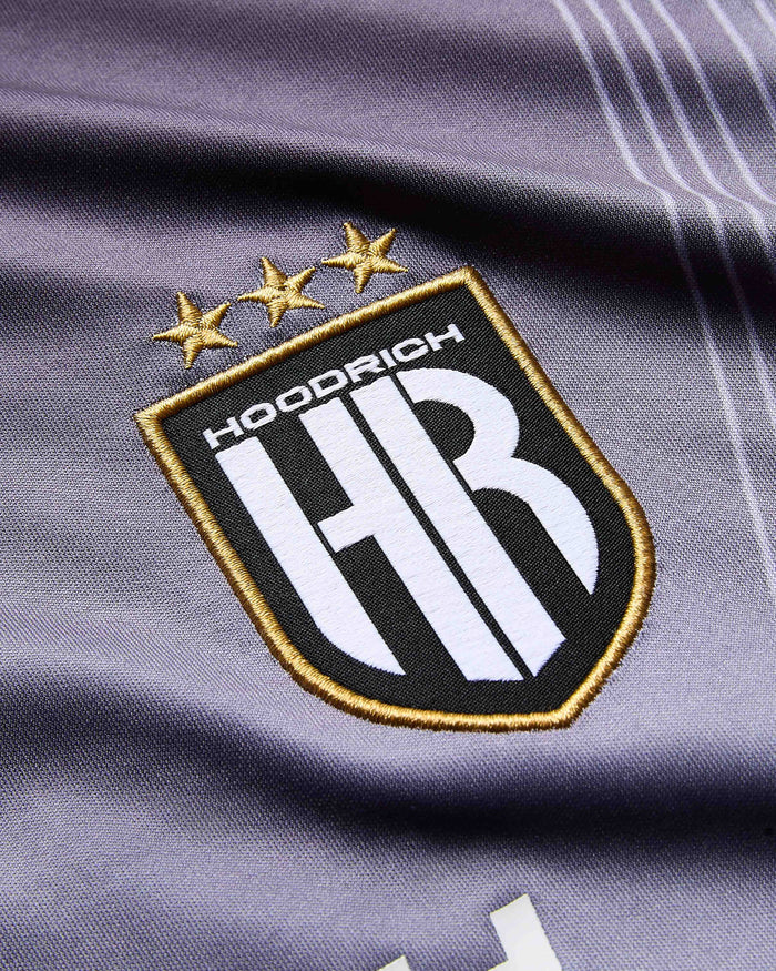 Close-up of a logo on a sports jersey with 'Hoodrich' branding.