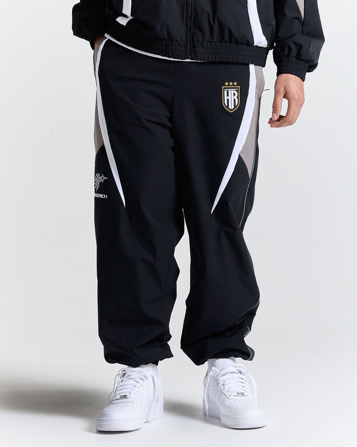 Black tracksuit with white accents and a logo on a white background