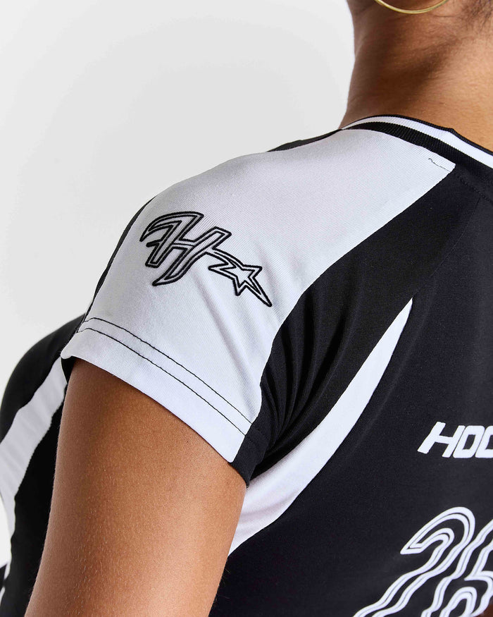 Black and white sports jersey with branding on a person wearing it.