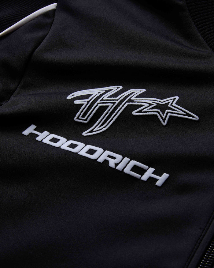 Black jacket with white logo and text on a dark background