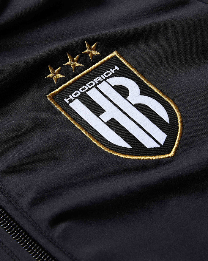 Embroidered logo on a black fabric background