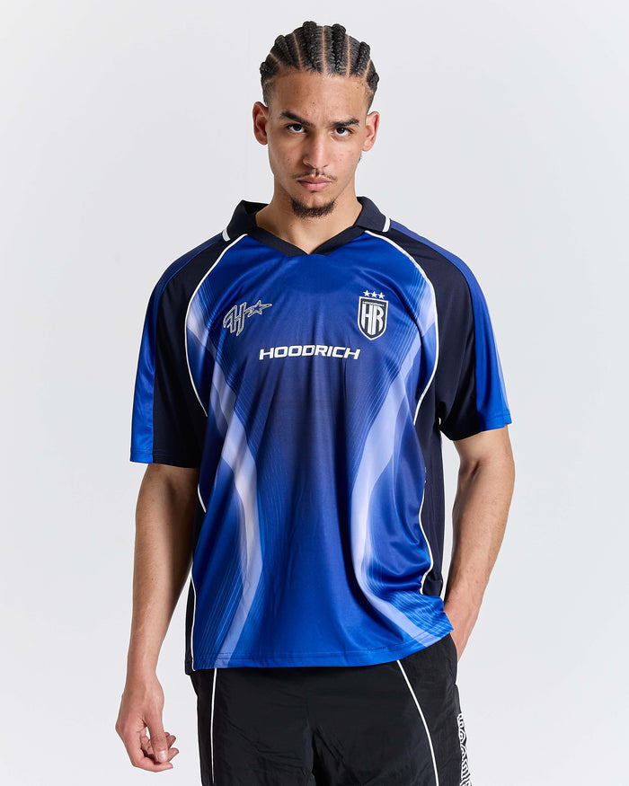Person wearing a blue sports jersey with visible branding on a white background