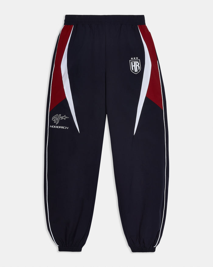 Navy tracksuit pants with red and white accents on a white background