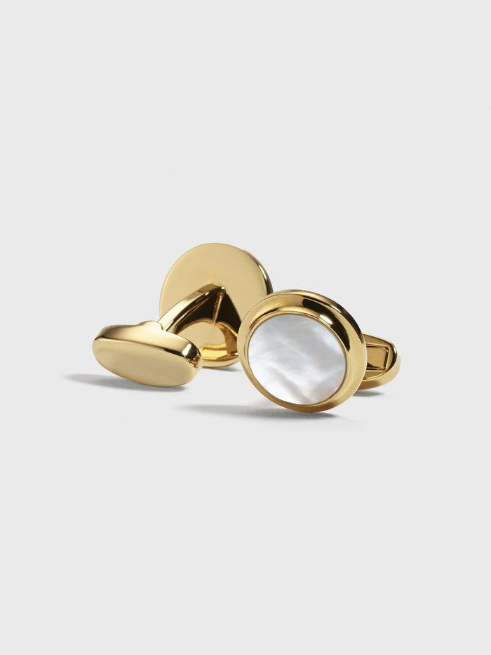Pair of gold cufflinks with mother-of-pearl inset.