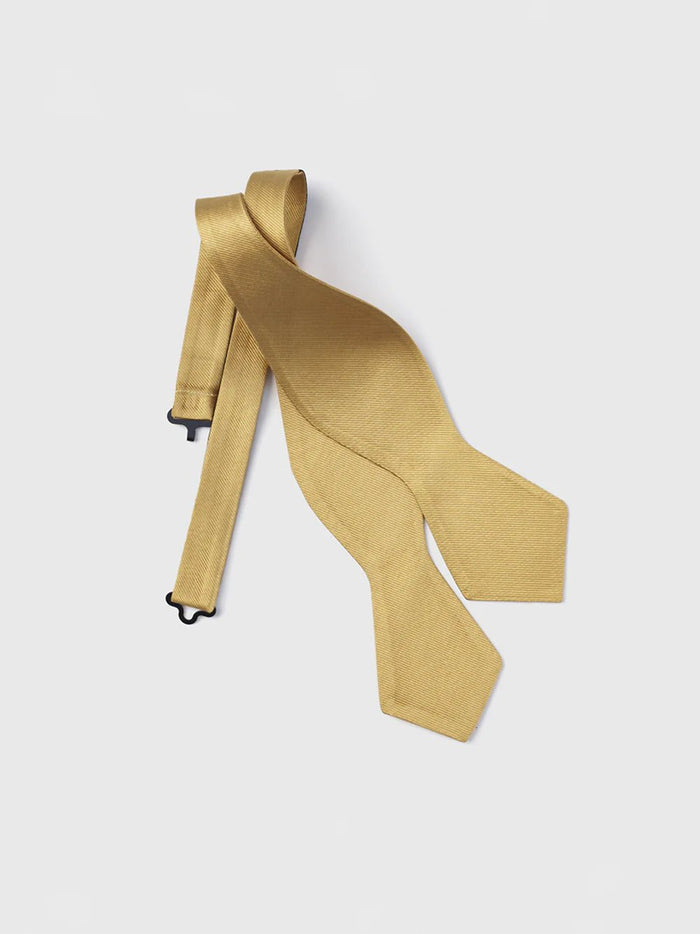 Gold silk self-tie bow tie, untied and laid flat.