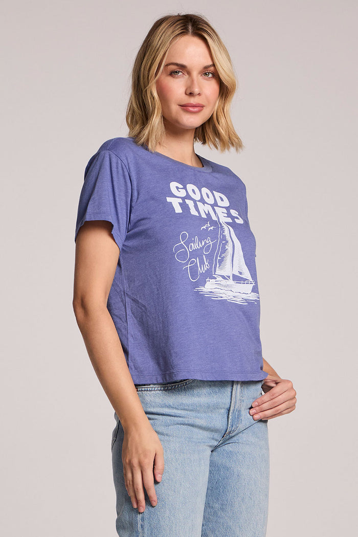 Side angle view of a woman wearing the Chaser Good Times Sailing Club Tee on a neutral background with a hand on her hip
