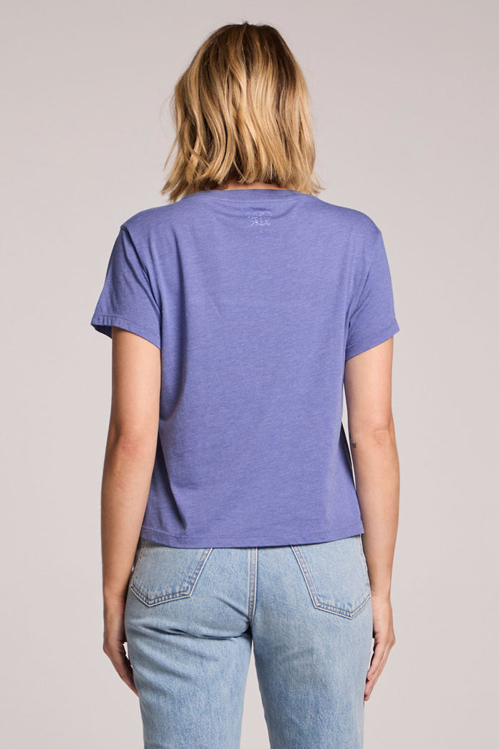 Back view of a woman wearing the Chaser Good Times Sailing Club Tee on a neutral background