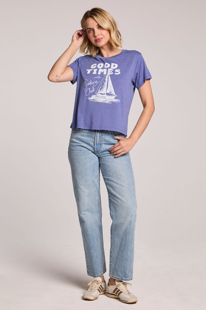 Full body front view of a woman wearing the Chaser Good Times Sailing Club Tee and sneakers on a neutral background
