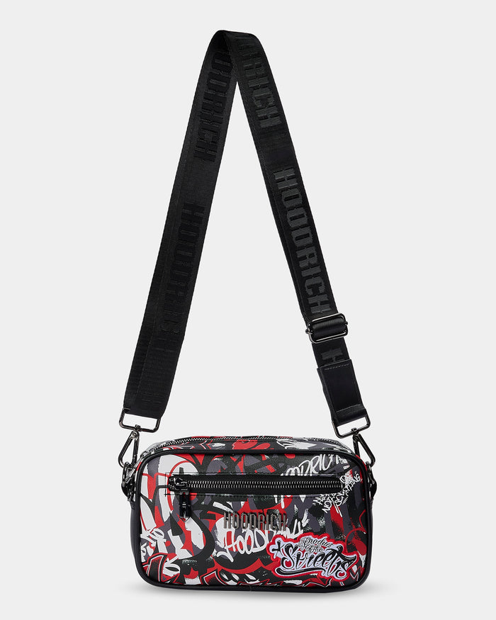 Crossbody bag with black strap and colorful pattern on a white background