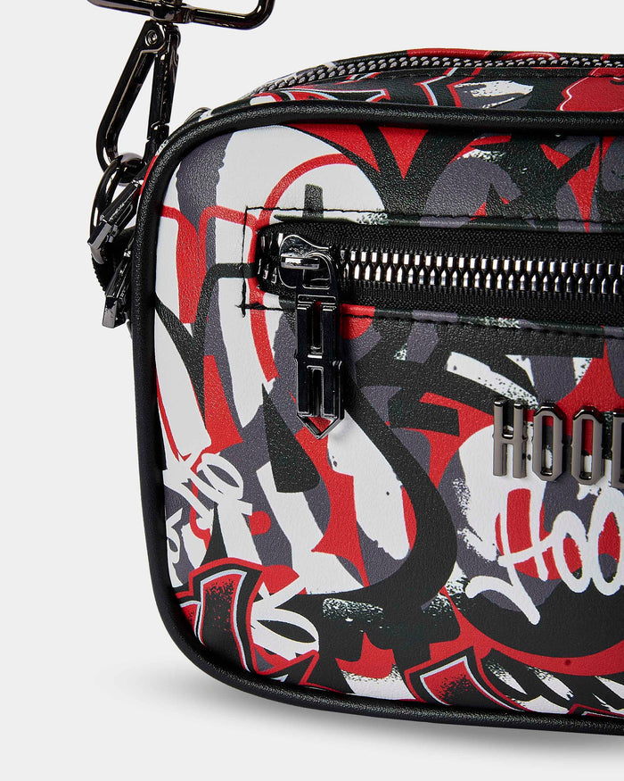 Graffiti-style bag with black, red, and white design on a light gray background