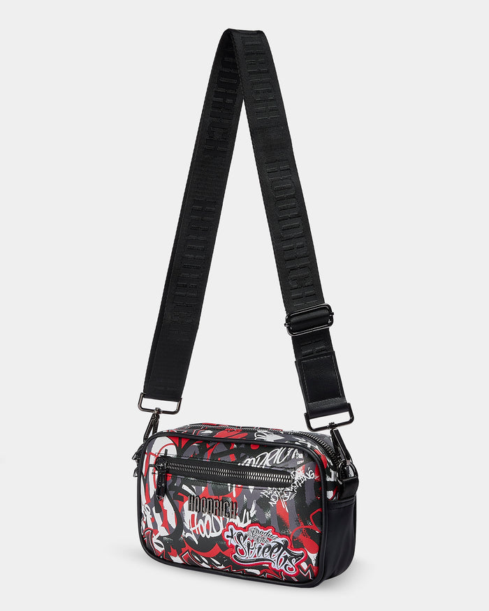 Black crossbody bag with red and white graphic design on a light gray background