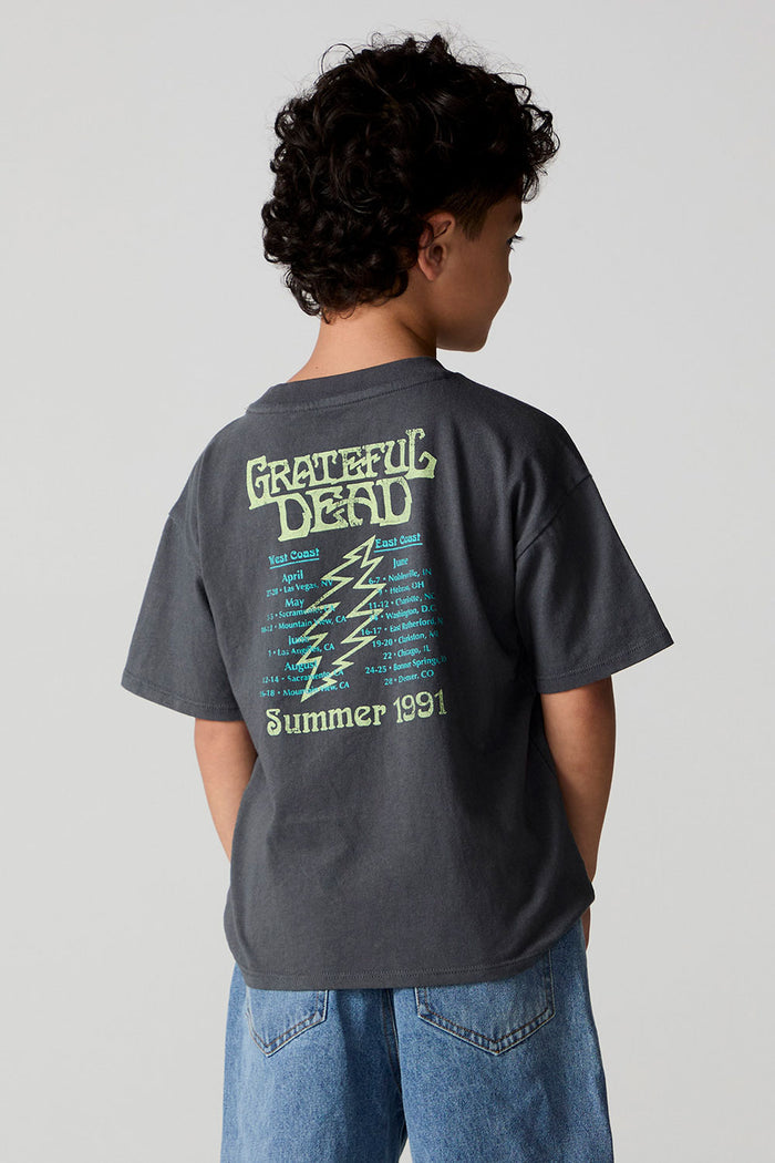 Back view of a boy wearing the Chaser Grateful Dead Tour Tee on a neutral background