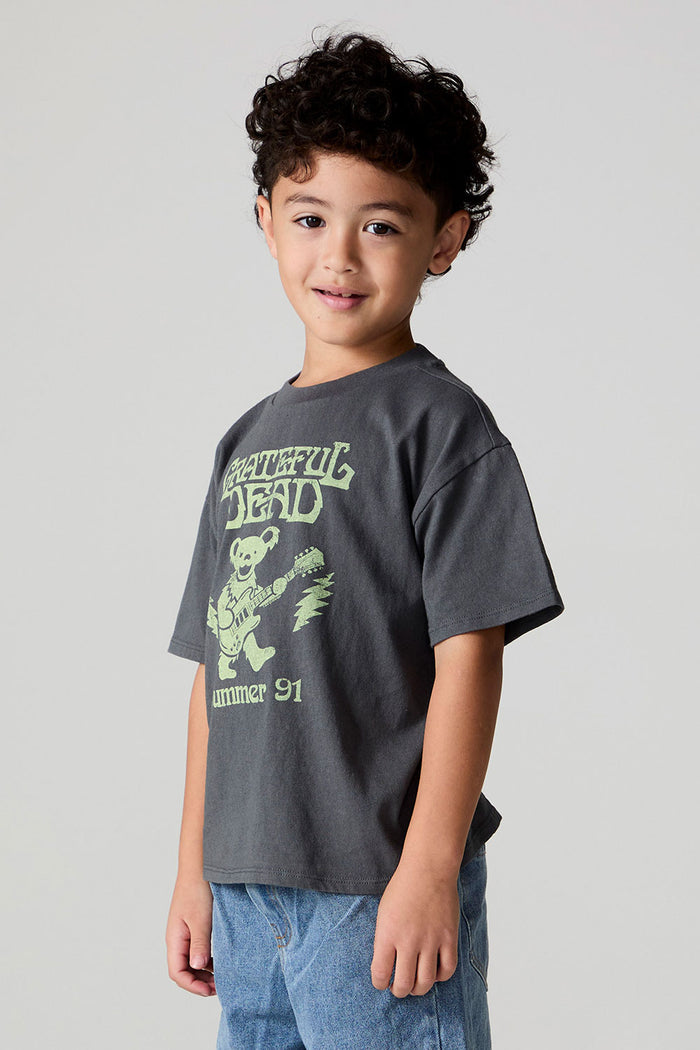 Side angle view of a boy wearing the Chaser Grateful Dead Tour Tee on a neutral background