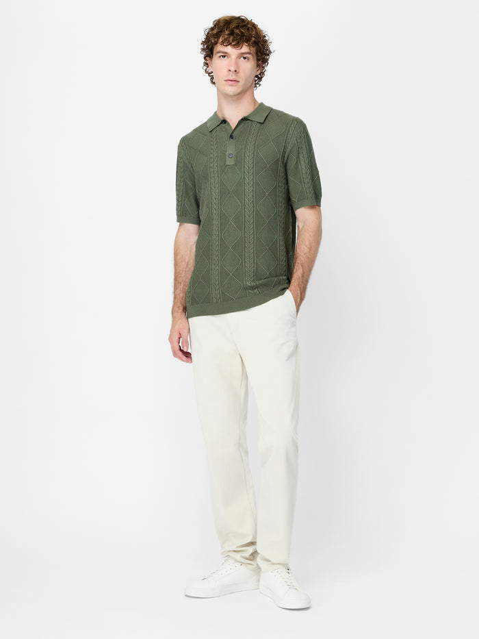 A man wearing a green knit Polo shirt
with short sleeves, a polo collar and a regular fit.
