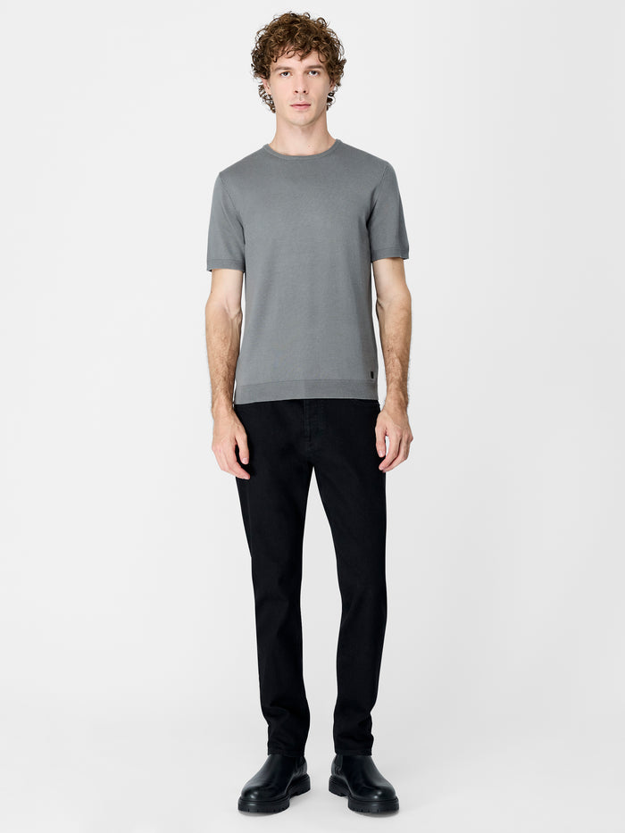 A man wearing a green knit T-Shirt with short sleeves, a ribbed crew neckline and a regular fit.