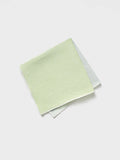 Folded green and off-white pocket square on a white background.