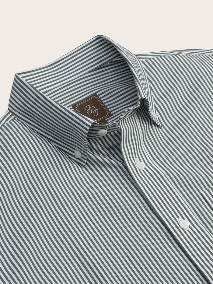 Close-up of a green and white striped shirt collar with brand tag.
