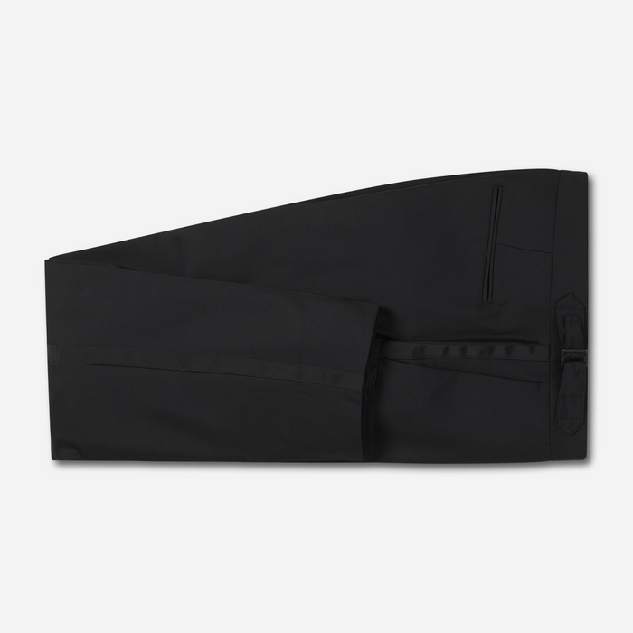 Black tuxedo trousers flat lay, satin side stripe and welt pocket visible