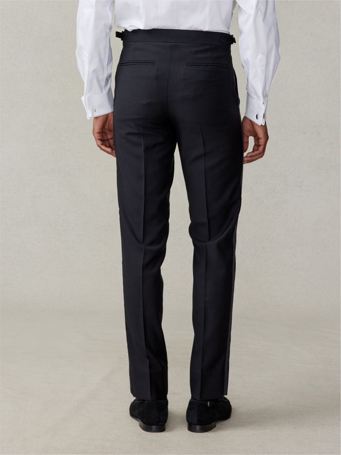 Back view of black tuxedo trousers, slim fit, cropped at waist