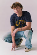 Full body view of model wearing navy Halftime 1984 tee.