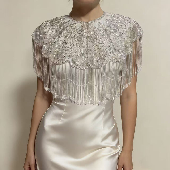 Luxury handmade beaded bridal cape with sequin embroidery and flowing fringe details for wedding dress styling.